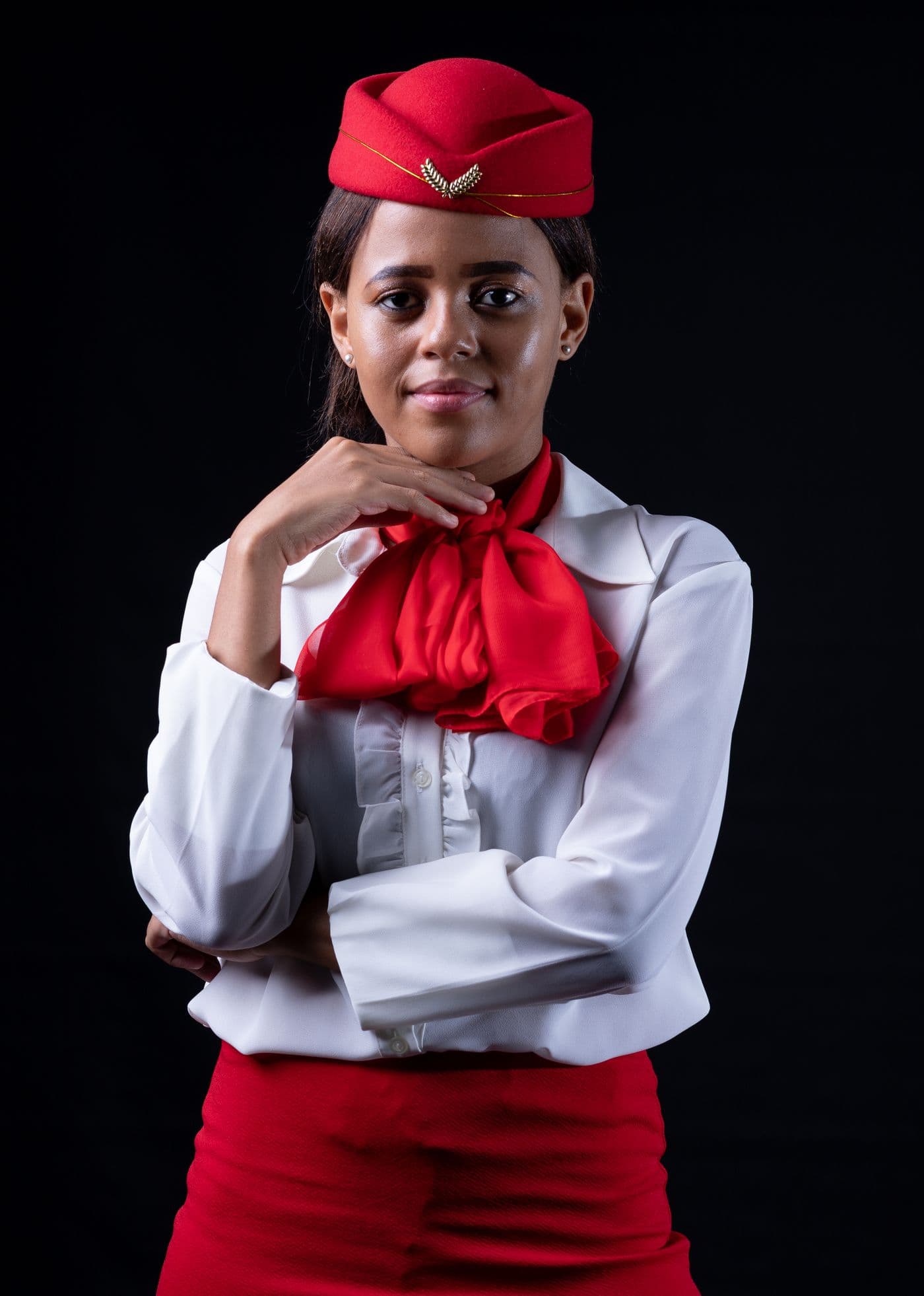 A cabin crew candidate in uniform, composed and looking straight at the camera